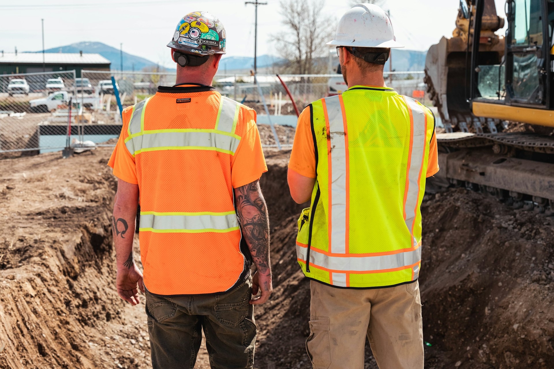 Two construction professionals looking over a working site